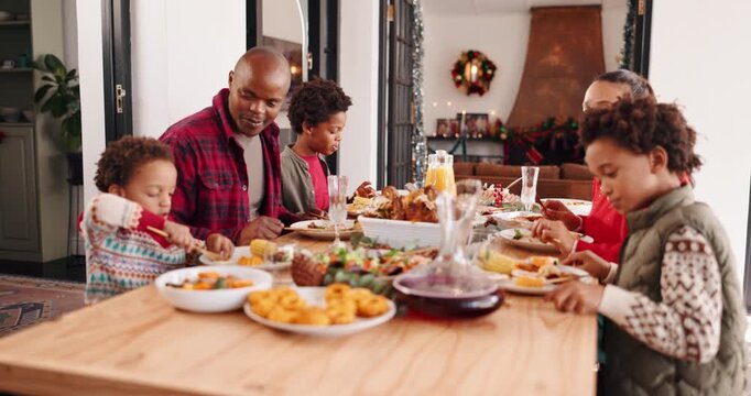 Christmas, parents and eating lunch with kids, talking and happy in family home. Xmas, father and mother with children for food, holiday celebration and teaching etiquette with hungry African people