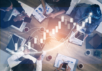 A diverse group of professionals engages in a dynamic business meeting, analyzing financial growth graphs and discussing strategies using digital devices. Impute