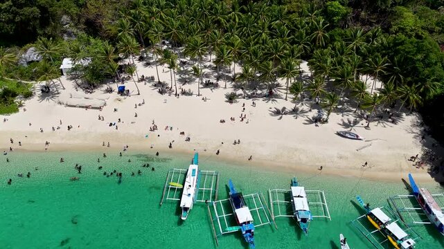 Seven commandos beach in El Nido, Palawan, Philippines islands. Aerial 4K drone video footage. Top view of beautiful turquoise beach, with white sand and palms