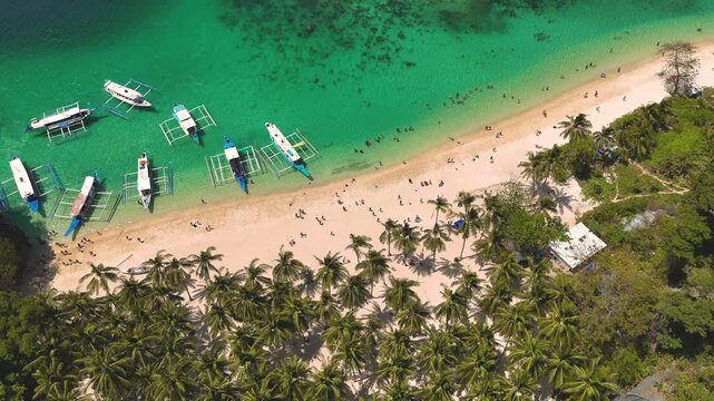 Seven commandos beach in El Nido, Palawan, Philippines islands. Aerial 4K drone video footage. Top view of beautiful turquoise beach, with white sand and palms