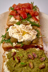 A Delicious Spread of Gourmet Toasts Featuring Creamy Cheeses, Fresh Vegetables, and Flavorful Toppings Perfect for a Light Meal or Snack