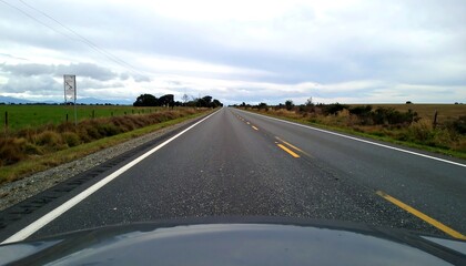 Empty rural road under overcast sky