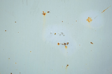 Close-up view of a weathered surface showing rust, stains, and marks that tell a story of exposure to the elements over time 