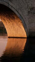 Close-up of ancient stone bridge at sunrise