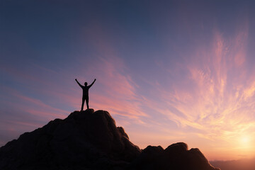 Man with Raised Arms on Mountain at Dawn