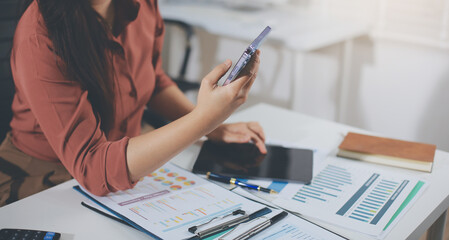 Closeup image of a businesswoman using mobile phone in office