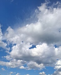 beautiful, light, white, fluffy clouds float across the blue sky during the summer season