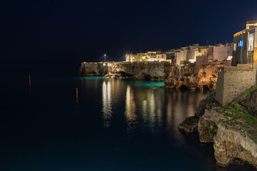 Night image of the beautiful and popular coastal town Polignano a mare in Italy.