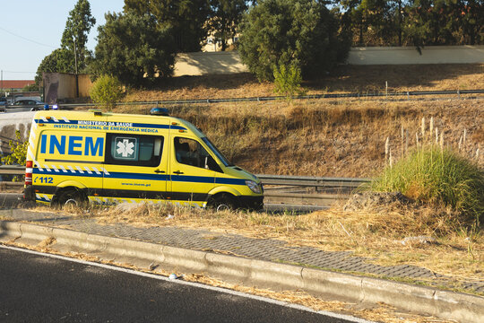 06-08-2025 An INEM ambulance (Instituto Nacional de Emerg&ecirc;ncia M&eacute;dica) from Portugal parked on the roadside during daylight. The vehicle, painted in yellow and blue with emergency medical