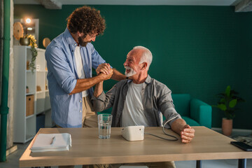 Doctor celebrating good news with patient about blood pressure test