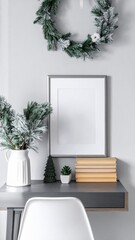 Christmas Wreath and Decorated Desk with Mockup Frame and Books in Minimalist Home Interior