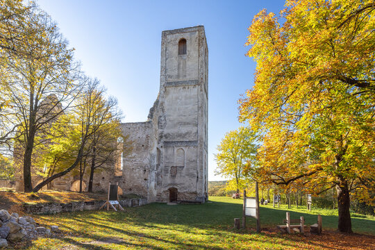 The Katarinka, ruins of a Franciscan monastery and church in Slovakia, Europe. Stone ruins stand tall amidst autumn trees, bathed in sunlight, blending history with natural beauty.
