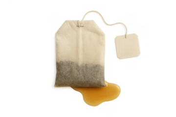 Steep tea bag releasing liquid droplets, showcasing warm beverage brewing process against clean minimalist backdrop
