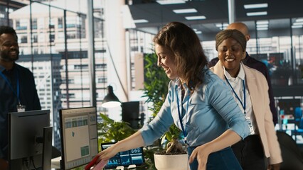 Happy employee starting first day at new job, unpacking belongings, meeting coworkers. Cheerful worker arriving in office, starting work on new company position, being welcomed by team, camera A