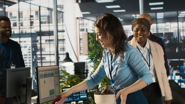Happy employee starting first day at new job, unpacking belongings, meeting coworkers. Cheerful worker arriving in office, starting work on new company position, being welcomed by team, camera A