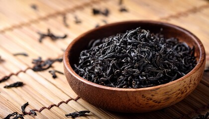 dried black tea leaves in a wooden bowl