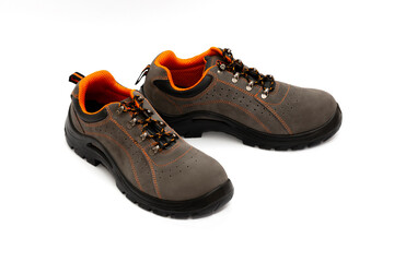 Brown safety leather work shoes with non-slip soles isolated on white background for men in factory or industry safety