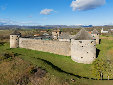 Aerial view of the Bzov&Atilde;&shy;k Cloister, with its robust stone walls and cylindrical towers, standing proudly against the backdrop of rolling hills, Bzov&Atilde;&shy;k, Krupina, Slovakia.