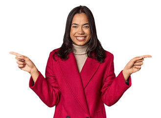 Young filipino woman pointing to different copy spaces, choosing one of them, showing with finger.