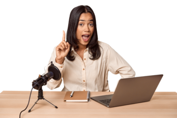 Woman records podcast with laptop having an idea, inspiration concept.