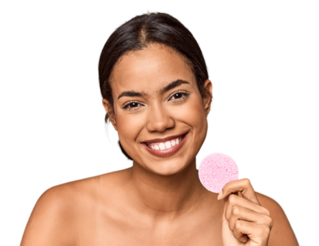 Woman holds facial sponge in studio touching back of head, thinking and making a choice.