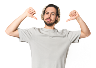 Young Caucasian man in studio setting feels proud and self confident, example to follow.