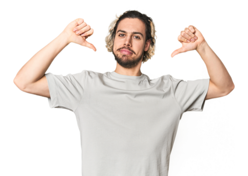 Young Caucasian man in studio setting feels proud and self confident, example to follow.