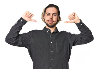 Young Caucasian man in studio setting feels proud and self confident, example to follow.