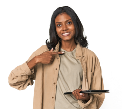 Young Indian woman with digital tablet person pointing by hand to a shirt copy space, proud and confident