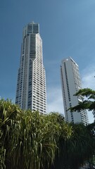 tall buildings with a blue sky background and trees below