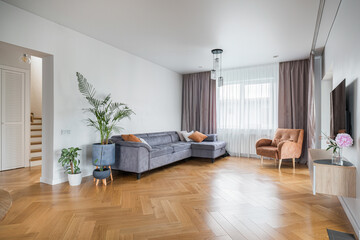 Modern living room with elegant furnishings and ample natural light during the day