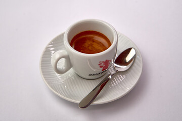 Deliciously Brewed Espresso Served in a Classic White Cup on a Saucer with a Silver Spoon Ready for Enjoyment