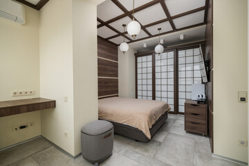 Comfortable bedroom with minimalistic design and sliding doors in a modern setting