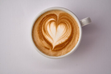Delightful Heart-Shaped Latte Art in a White Ceramic Cup Captured from Above on a Clean White Surface