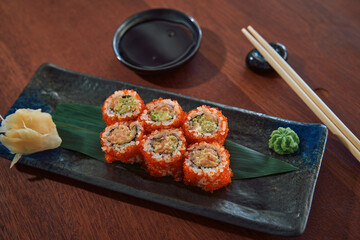 A Detailed Look at a Delicious Sushi Platter Featuring Colorful Rolls, Accompanied by Wasabi, Pickled Ginger, and Soy Sauce for an Authentic Dining Experience
