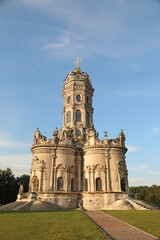 Beautiful baroque medieval style old church building on nature bright day light under blue sky background on the hill. Europe religion architecture building	

