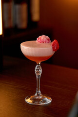 An Elegant Cocktail Garnished with Fresh Strawberries and Edible Flowers, Perfect for Celebrations or Relaxing Evenings