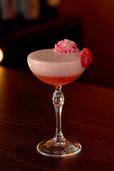 A Delicate Strawberry Cocktail Topped with Edible Flowers in an Elegant Glass, Perfect for Celebrations and Refreshing Summer Nights