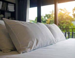 Cozy Bedroom Interior with Bright Morning Light Reflecting on White Pillows