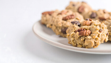 A plate of cookies with nuts and chocolate chips