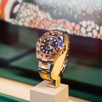 Palma, Spain - Jul 15, 2025: Close-up of Rolex GMT-Master II with black and brown ceramic bezel, stainless bracelet and polished design displayed under boutique lighting.