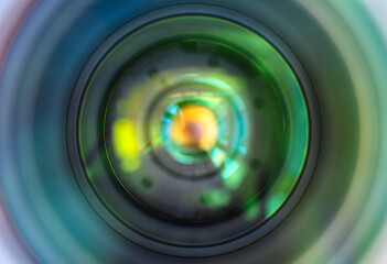 Close-Up View of a Camera Lens with Colorful Reflections in a Studio Setting