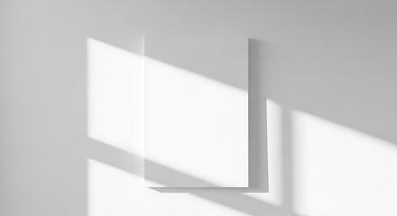 Fototapeta premium Minimalist white blank canvas casting geometric shadows on white wall