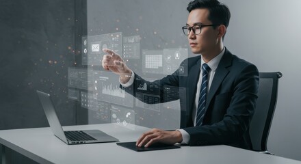 Innovative businessman working on a laptop and interacting with a futuristic holographic user interface displaying data analytics.