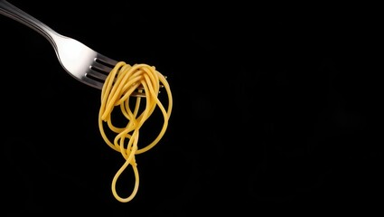 A fork twirling spaghetti against a dark, dramatic background 