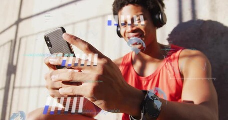 Seated man tapping smartphone opening fitness app and viewing animated data charts in sunlight - Powered by Adobe