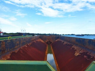 Inside view of an empty rusty hopper barge for dredging
