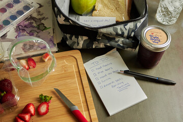 Still life fkatlay of school lunch box prep and chaos with cheeky to-do list. 