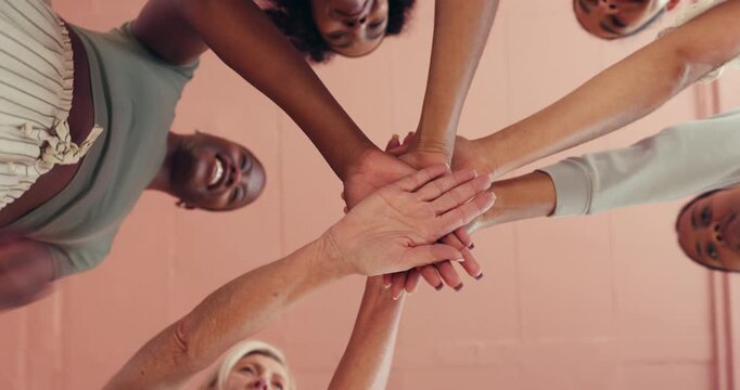 Huddle, motivation and stack of hands with women in studio together for health, wellness or yoga from below. Fitness, palm and solidarity with group of friends in circle for support or team building