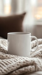 Fototapeta premium White Ceramic Mug on Cozy Knit Blanket by Soft Morning Light